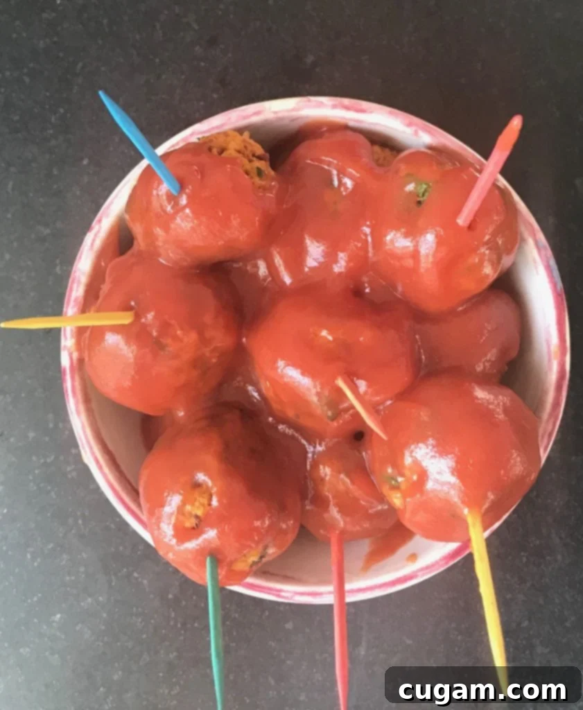 A beautiful close-up of Vegan Sweet and Sour Meatballs in a stylish small dish, ready to be served at a party. 