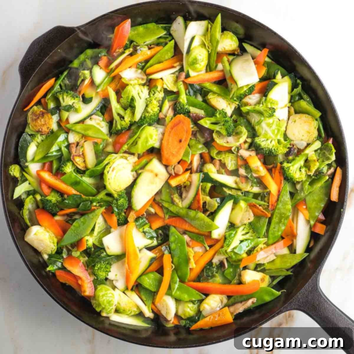 Softer vegetables (broccoli florets, mushrooms, bell peppers, bok choy, snow peas) added to the wok and stir-fried with the harder vegetables.