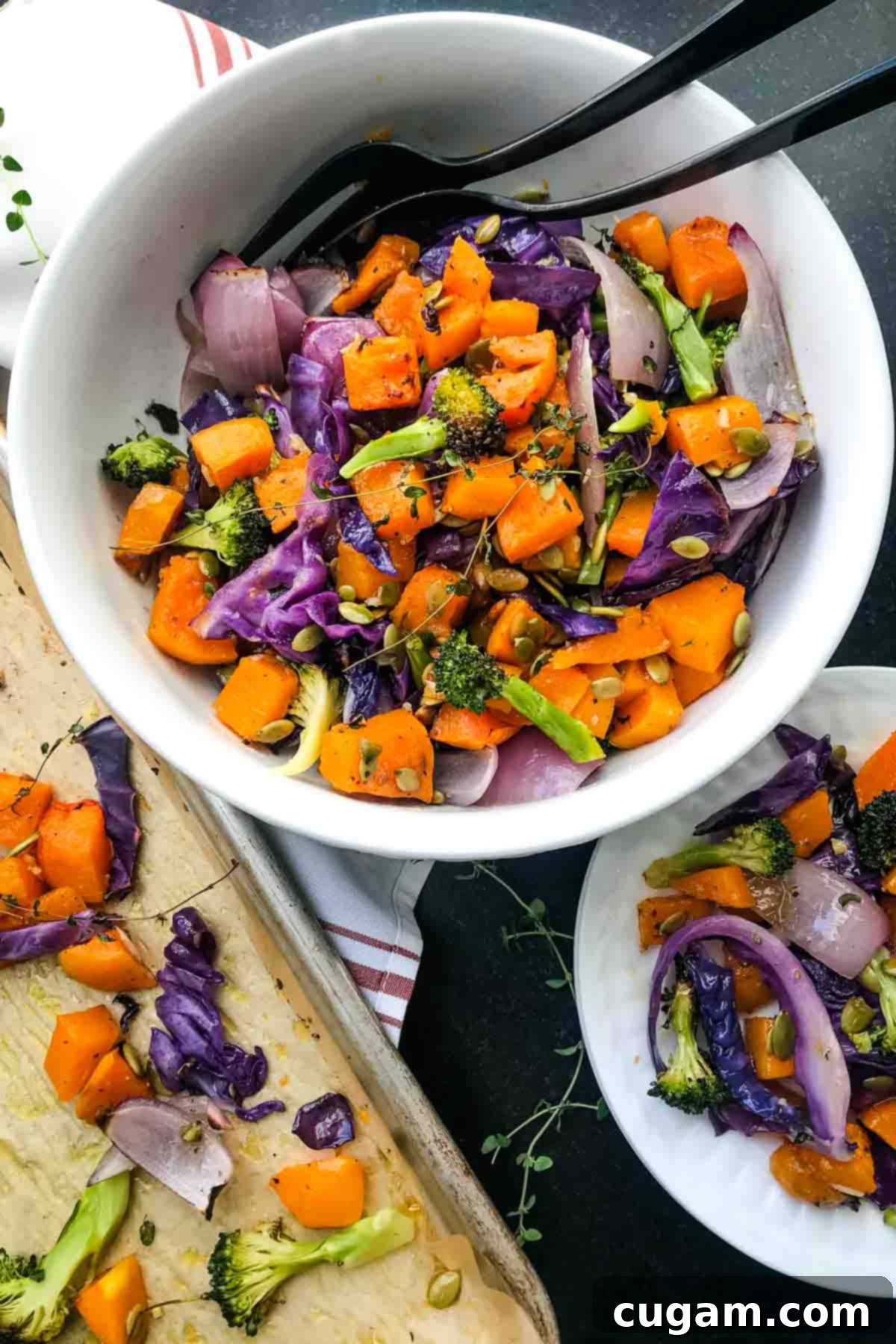 Roasted butternut squash, broccoli, onions and cabbage with pumpkin seeds in a bowl. A inviting bowl of freshly roasted vegetables, garnished with pepitas.