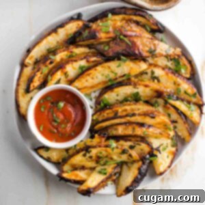 Crispy potato wedges with a dish of ketchup.