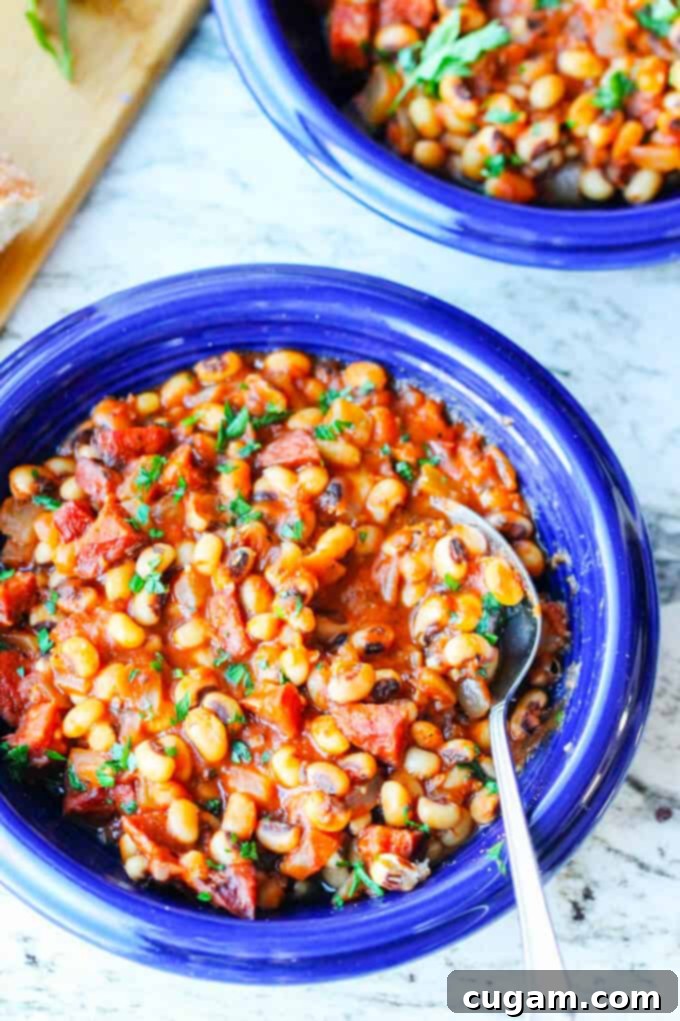 breton beans with sausage and tomatoes on blue plate with spoon
