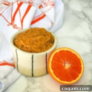 Halved orange plus a dish with thick orange marmalade.