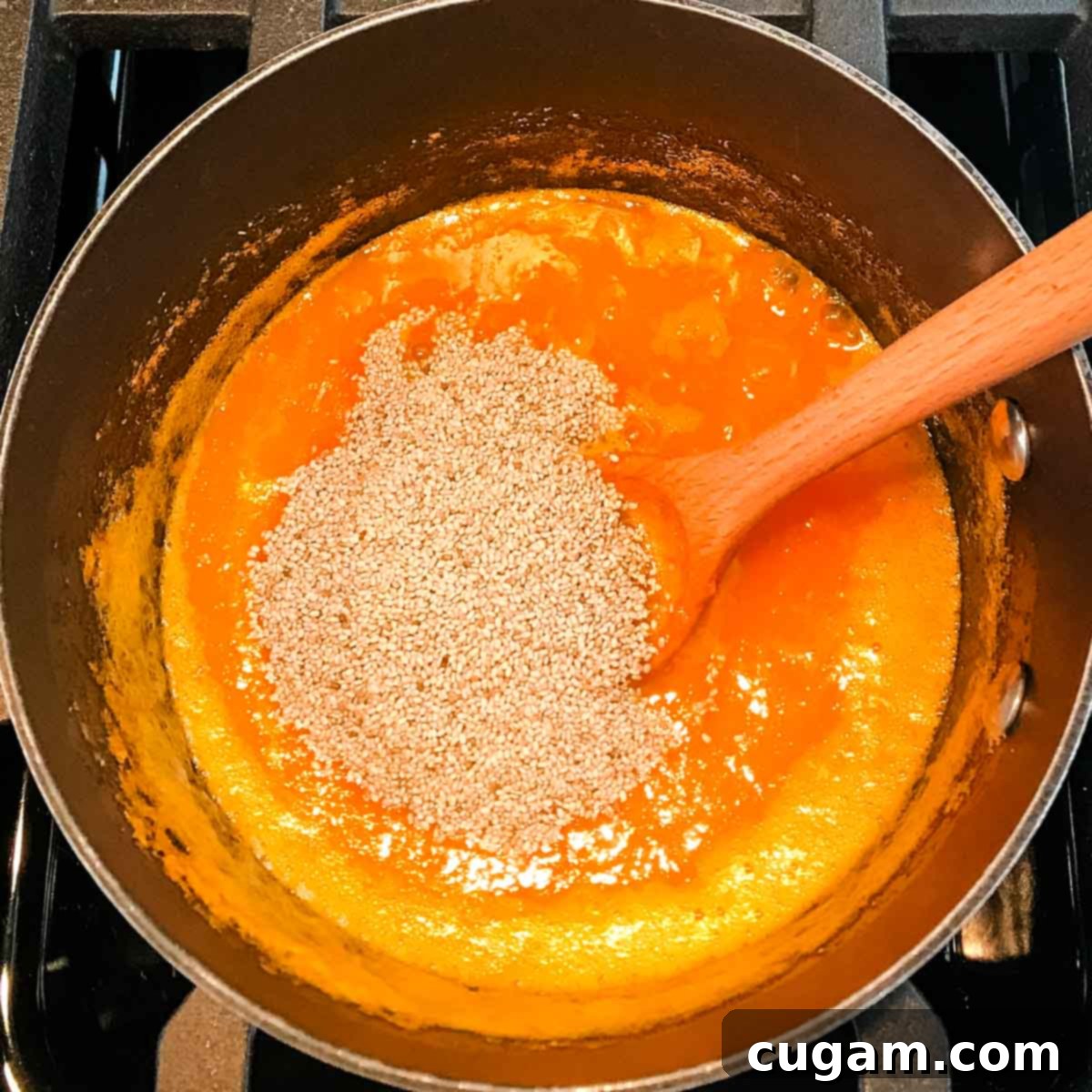 Orange juice mixture in a saucepan with chia seeds.