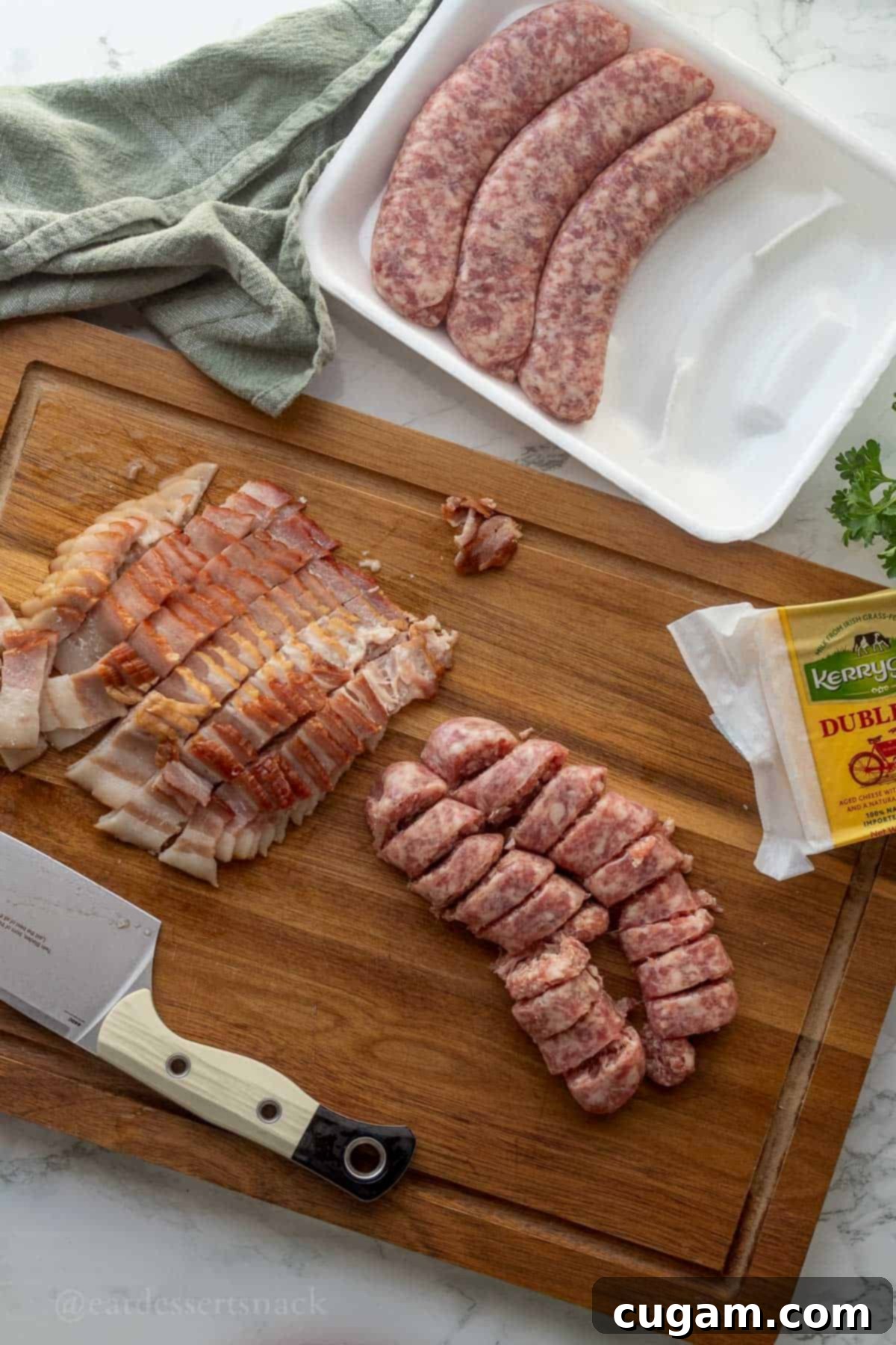 Raw sliced sausage and bacon on wood cutting board.