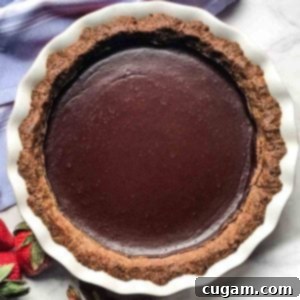 Pecan and date crust filled with chocolate pudding for a chocolate pie.