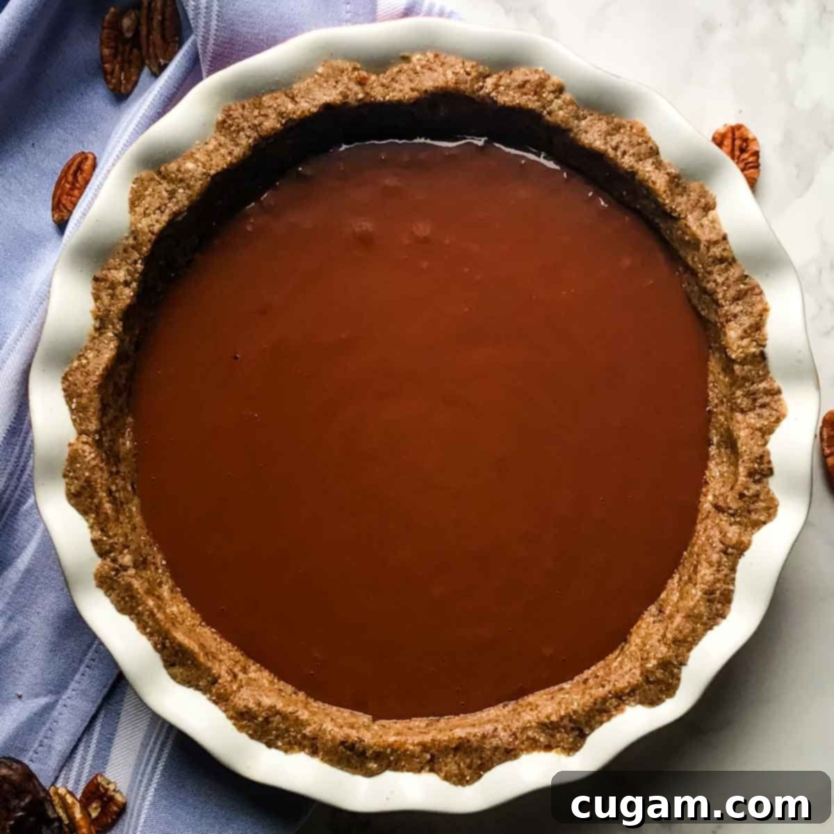 Indulgent Healthy Chocolate Pudding Pie 10 Chocolate pudding filling poured into a nut crust, ready to bake into a luscious healthy chocolate pie.