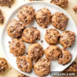 A beautifully presented plate full of Gluten-Free Double Chocolate Chip Cookies, generously sprinkled with flaky sea salt.