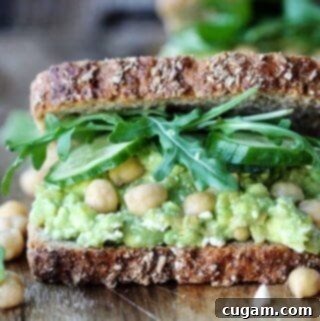 Close-up of a Smashed Chickpea Avocado Feta Sandwich, horizontal view, highlighting its fresh and creamy texture.