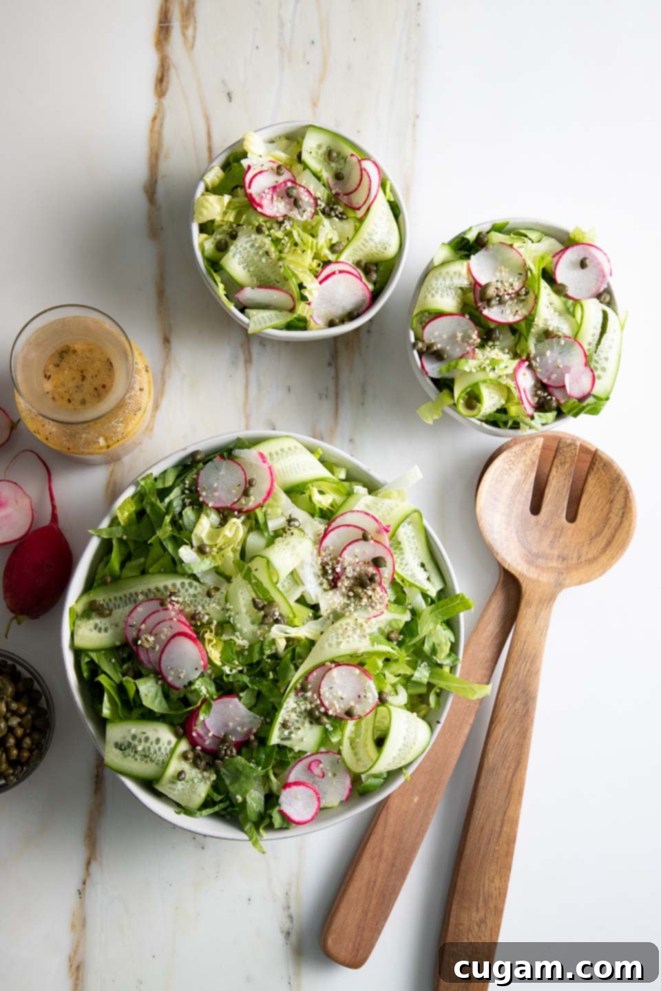 Bowls of crisp green salad with fresh vegetables, ready for dressing, highlighting healthy eating.