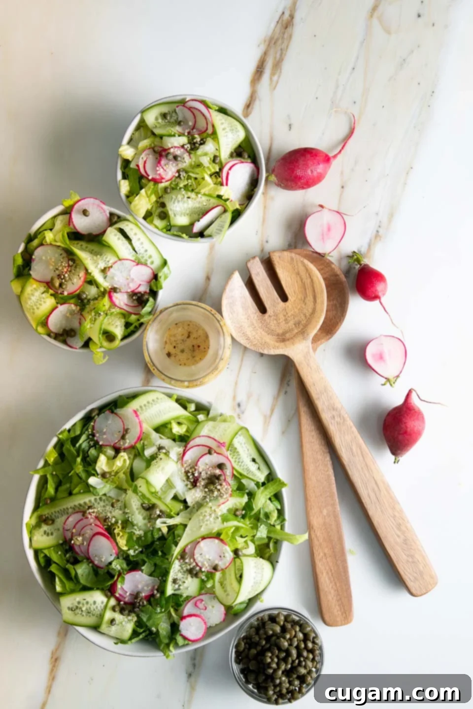 Close-up of a vibrant green salad generously garnished with thinly sliced radishes and briny capers, highlighting the unique textures and flavors.