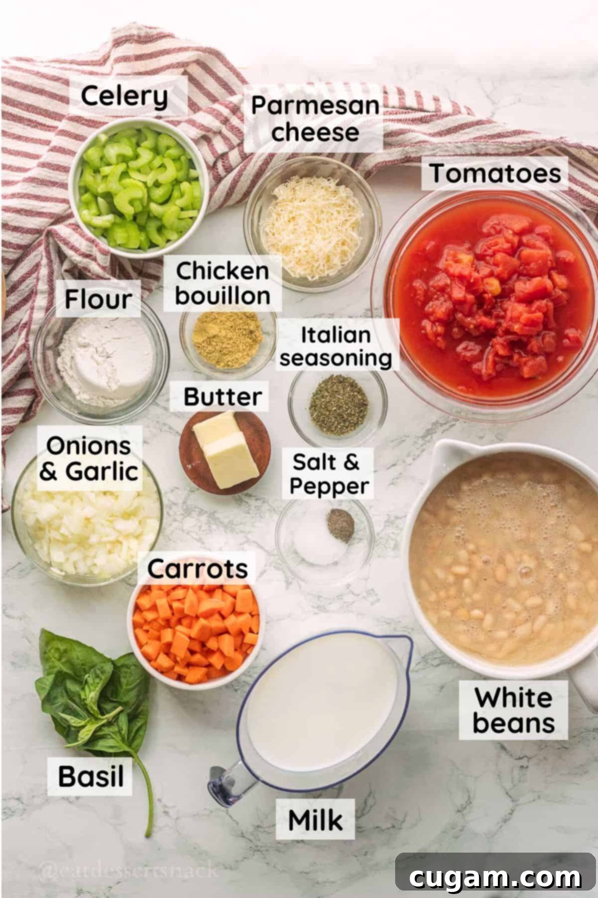 Ingredients for tuscan white bean soup in glass bowls on marble countertop.