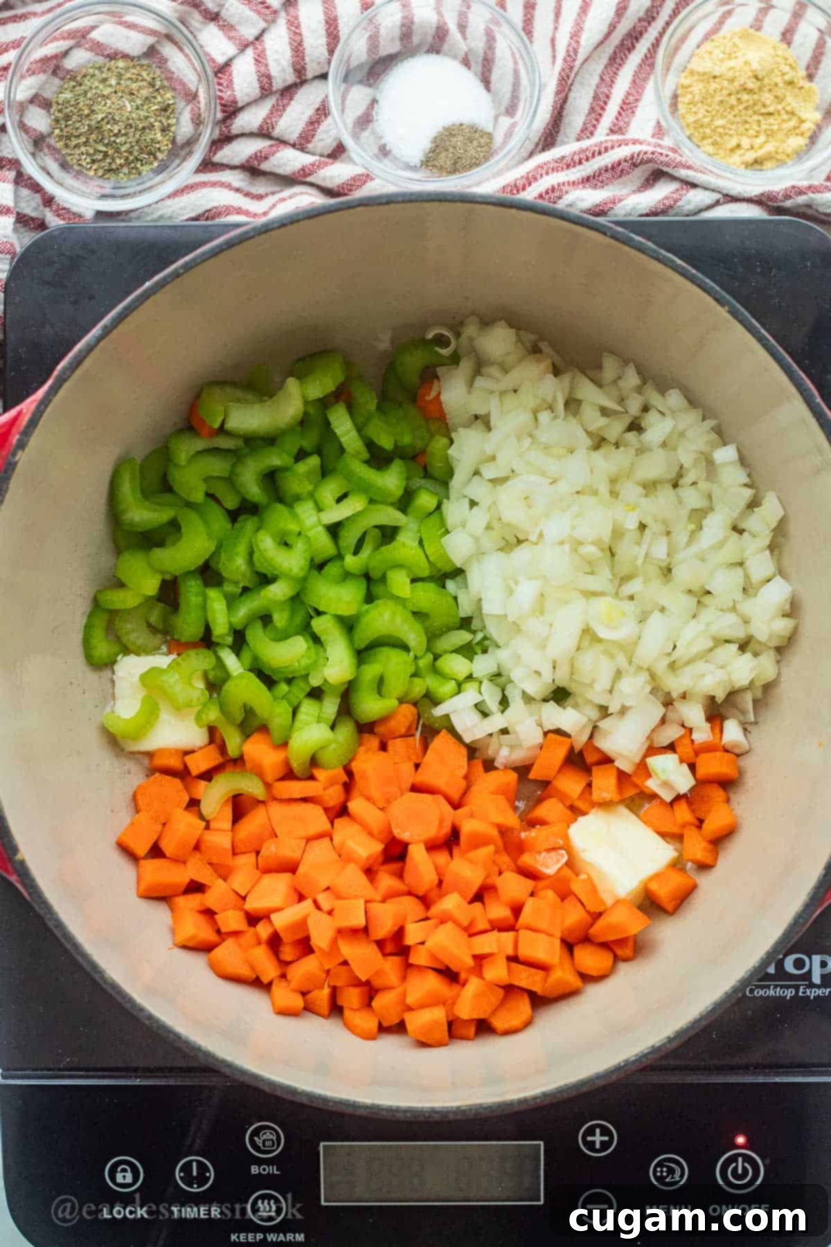 Onions, carrots, and celery in a pot with butter.