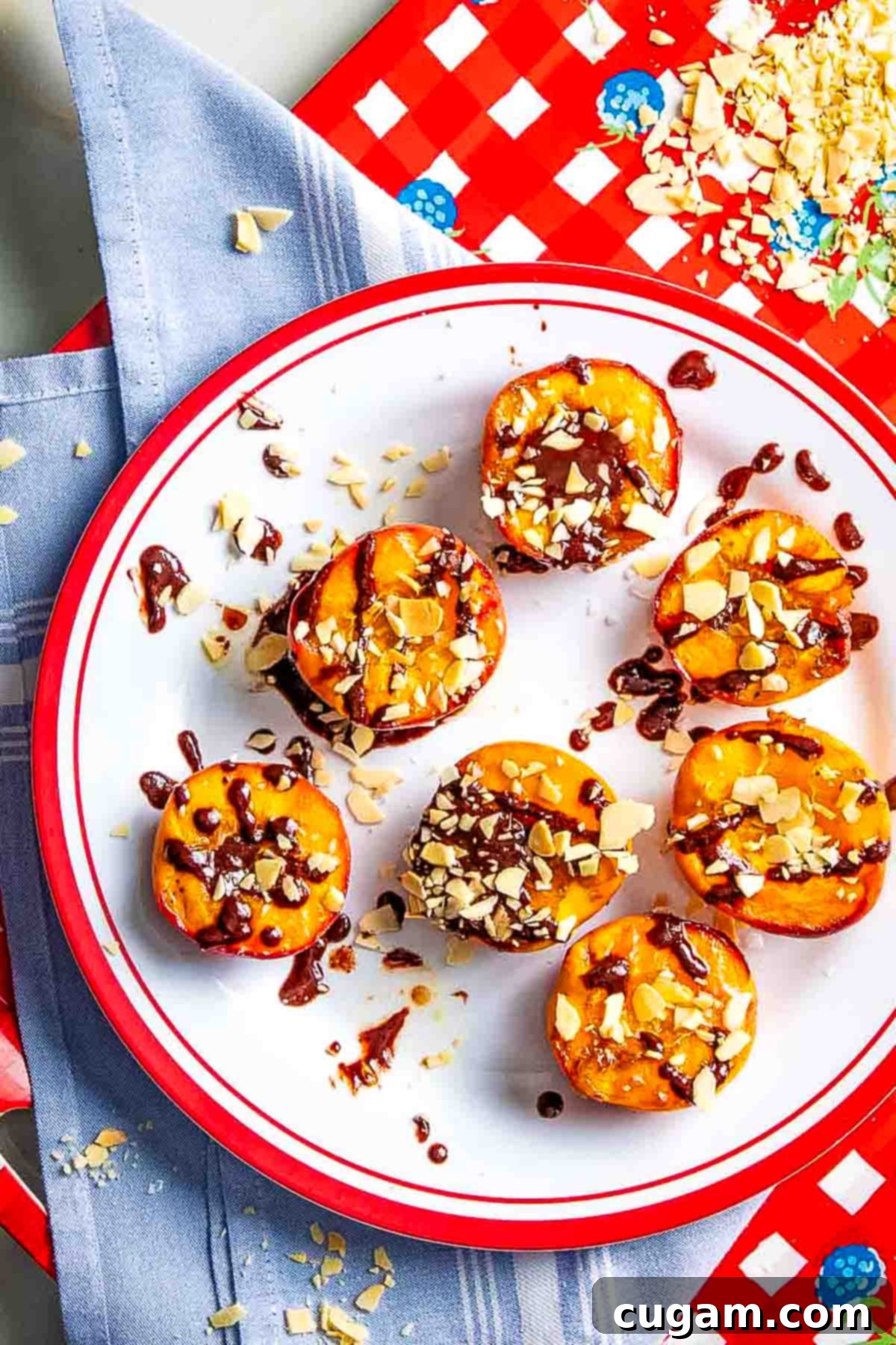 Grilled peaches, drizzled with chocolate and sprinkled with nuts and salt. A perfect healthy summer dessert.