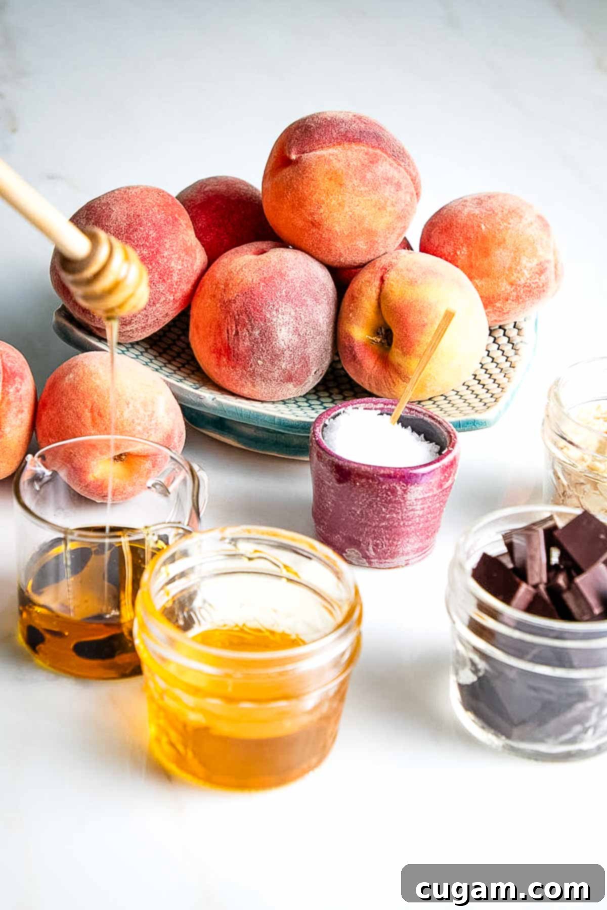 Peaches, with small dishes of chocolate, oil, salt, balsamic vinegar. Ingredients for grilled peaches.
