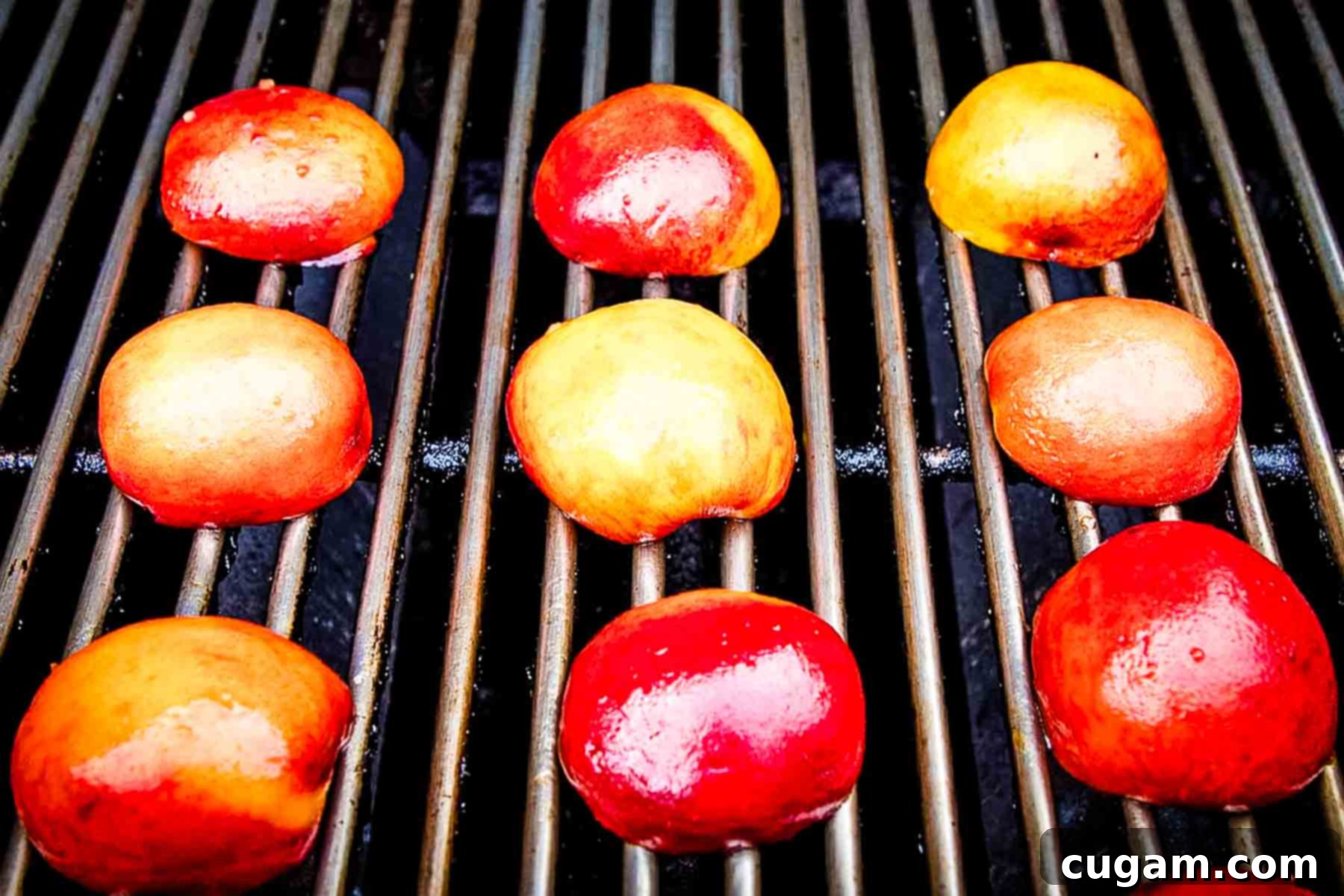 Halved peaches, face down on a grill, getting grill marks.