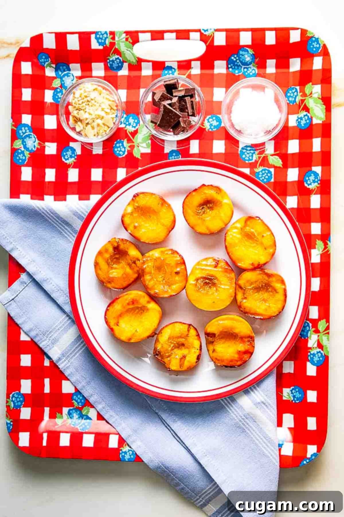 Grilled peaches transferred to a serving plate.