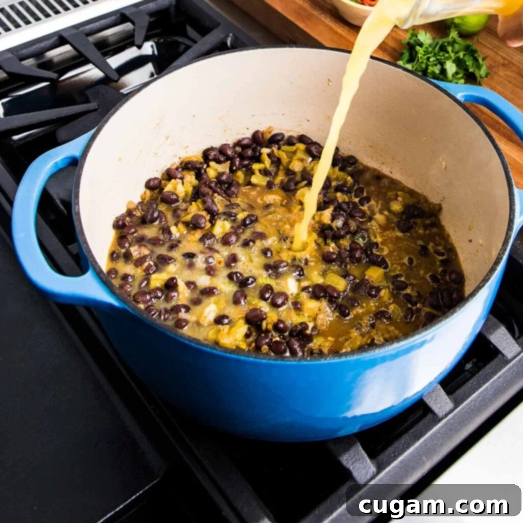 Black beans and green chiles added to the pot with vegetables and spices.