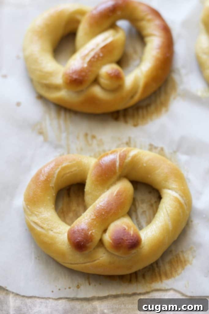 Baked Pretzels in a pan on parchment paper.