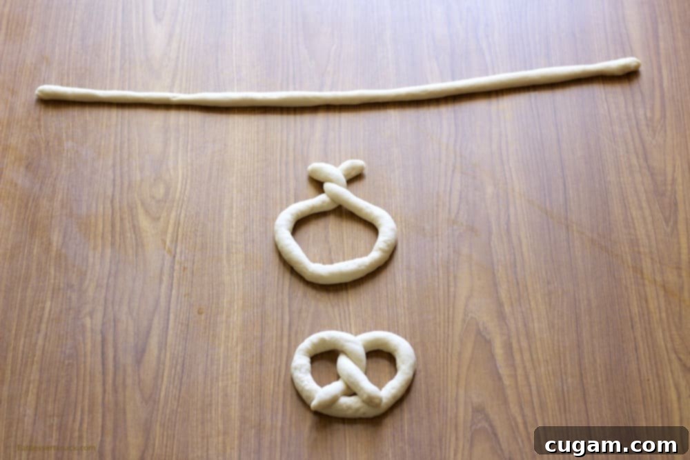 Stages of raw pretzel dough being twisted into shape on a brown table.