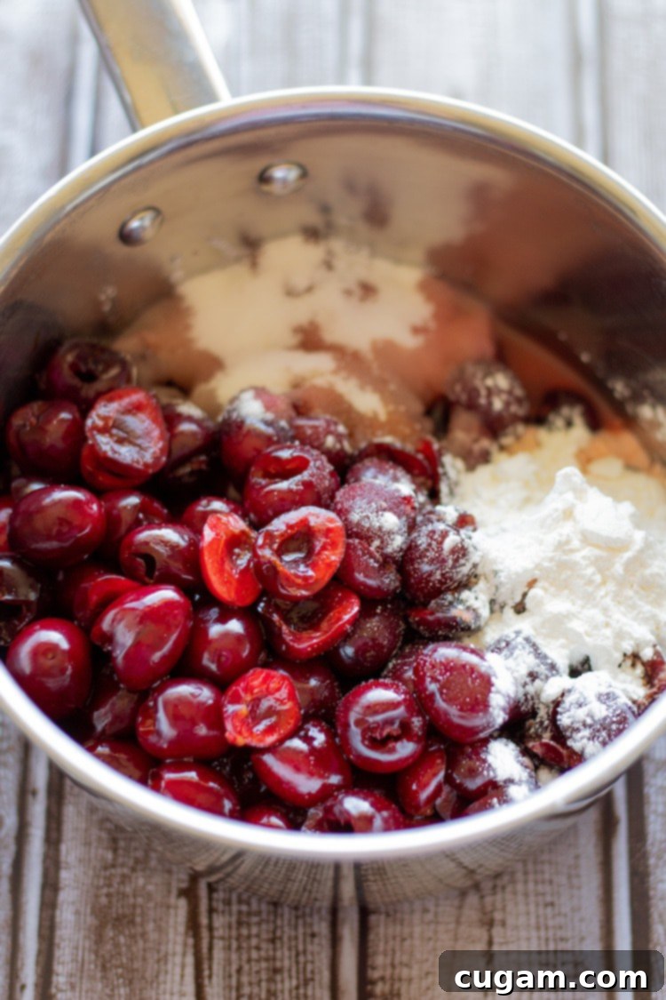 Raw homemade cherry pie filling ingredients in a pot. 