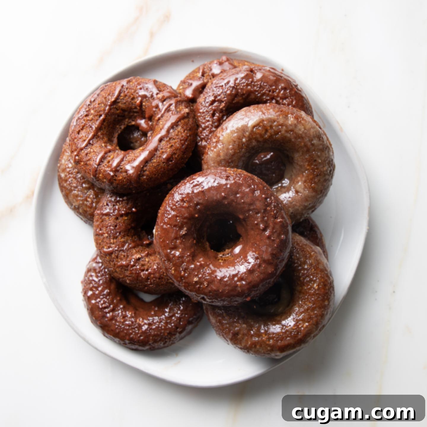 A plate of glazed pumpkin donuts