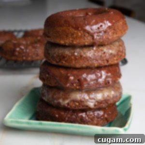 Pile of pumpkin donuts with maple or chocolate glaze dripping down.