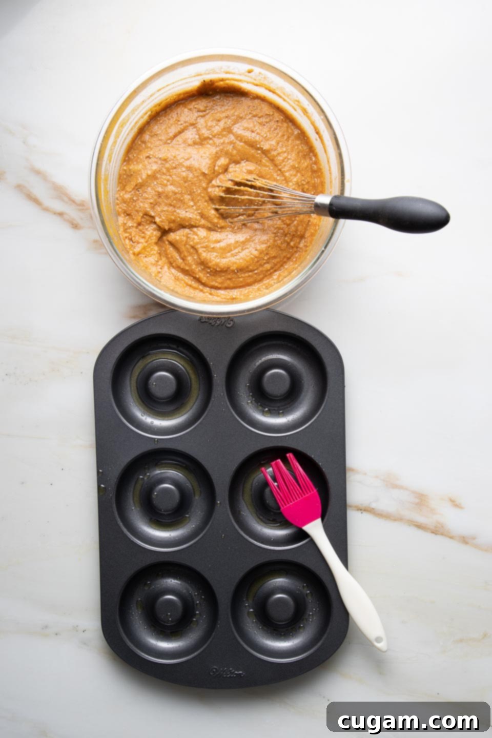 Brush donut pan with oil and fill with pumpkin batter. 