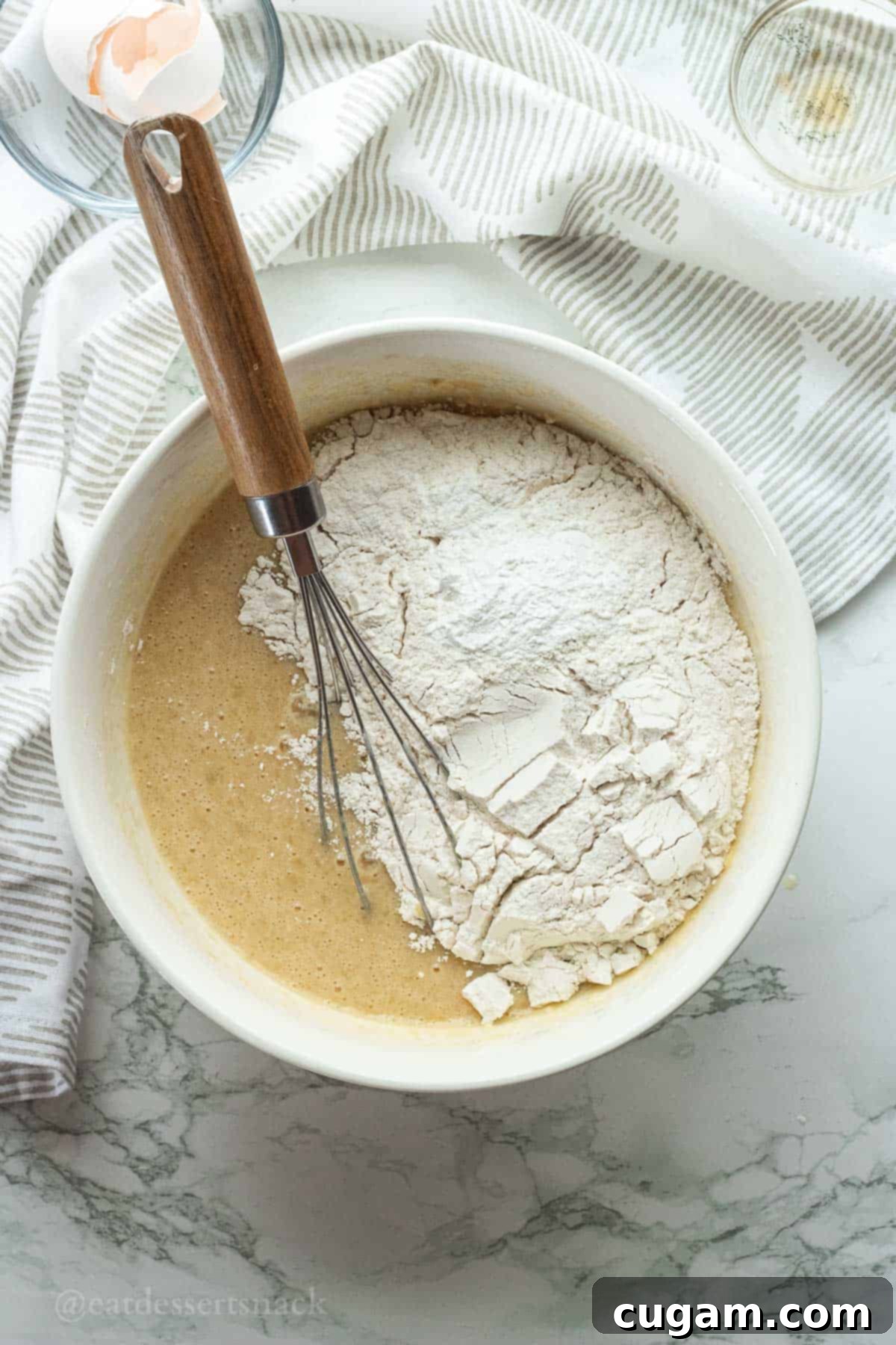 Flour and whisk in bowl of wet ingredients.