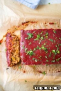 A thick slice of vegan meatloaf with tomato glaze.