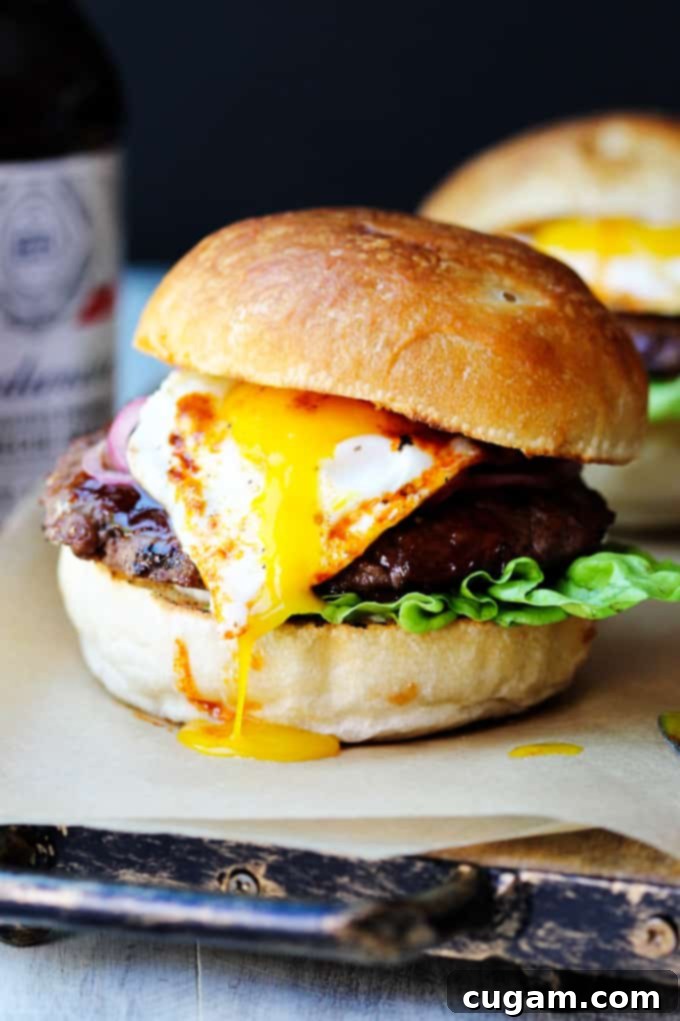 Smoky BBQ Burger with runny egg yolk, a perfect summer meal with Budweiser sauce