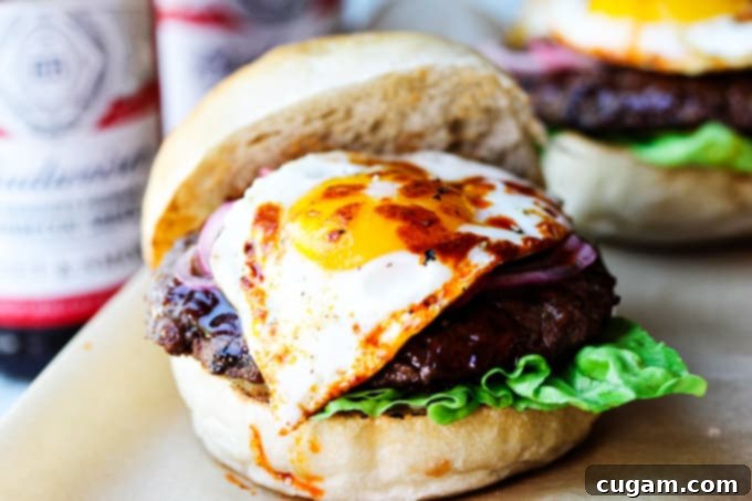 Smoky BBQ burger with fried egg, paprika, and herbs
