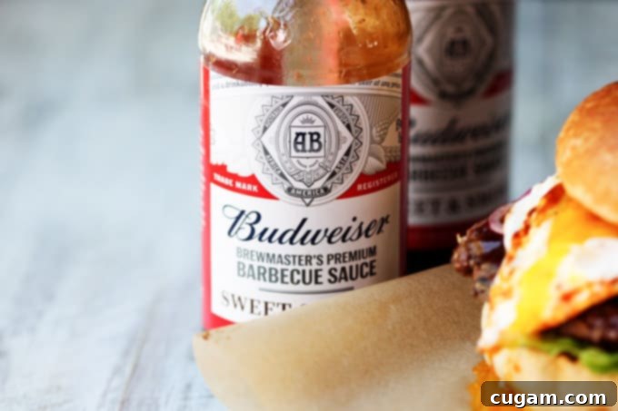 Budweiser BBQ sauce bottles on a wooden surface