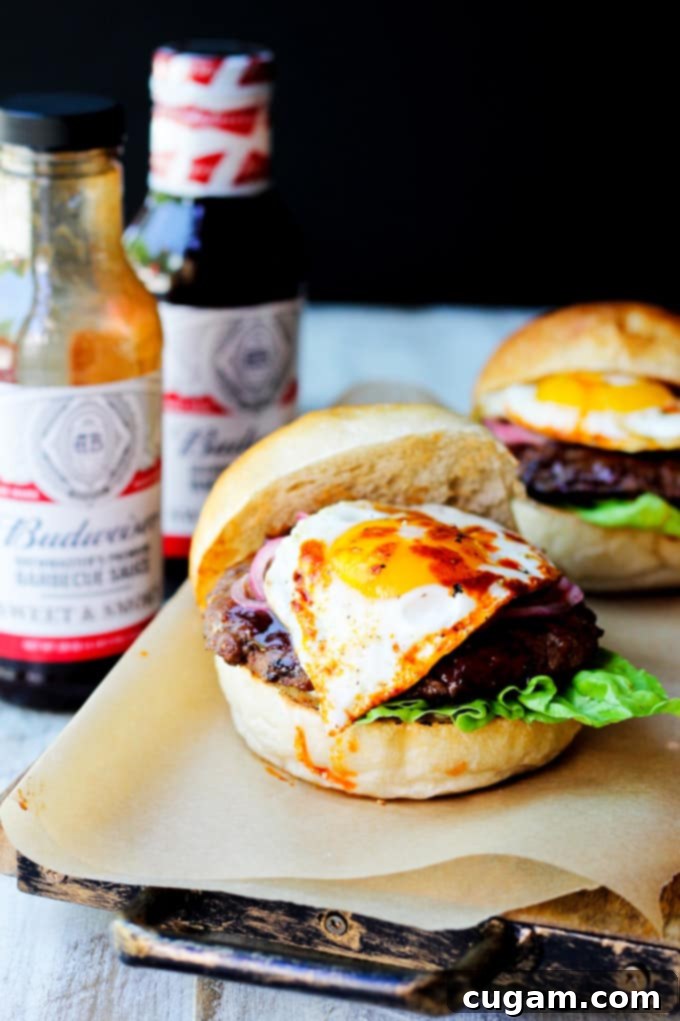 Smoky BBQ Burgers with Budweiser sauces arranged on a platter