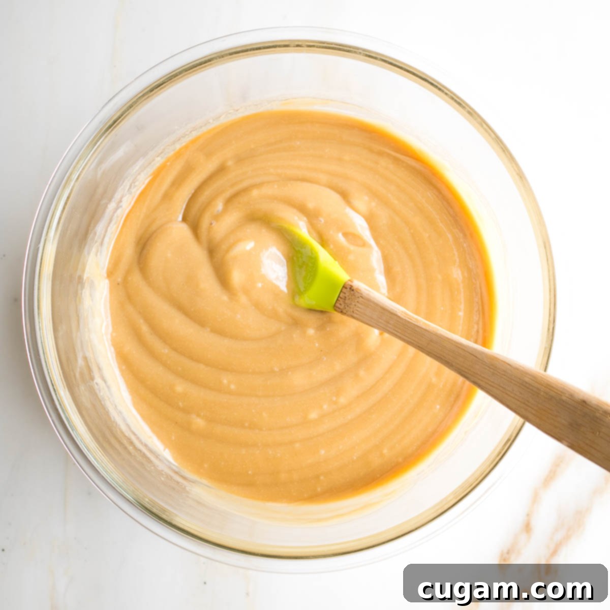 Tahini mixture for brownies, showing the smooth, combined consistency of tahini, maple syrup, and vanilla.