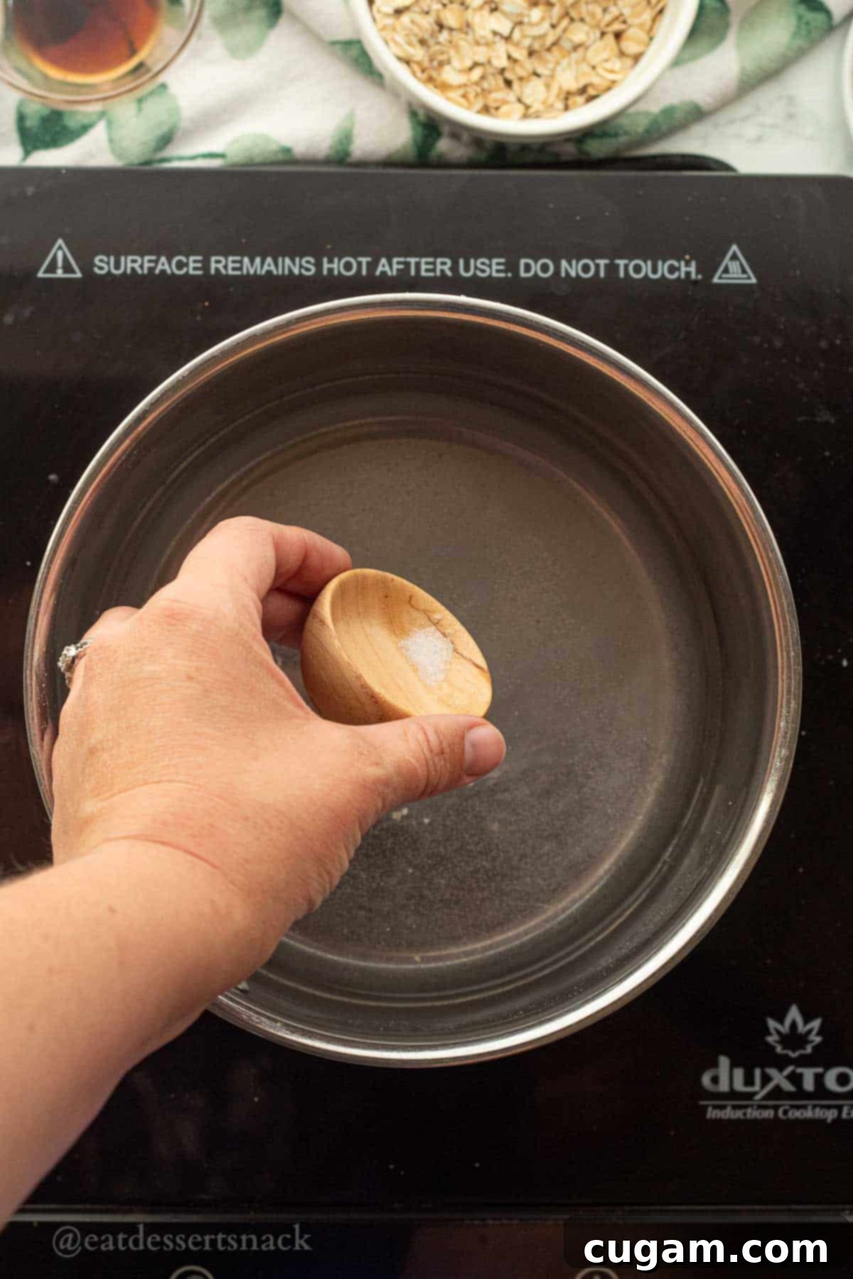 Banana Nut Oatmeal Bliss 4 Salt pouring into pot of water.