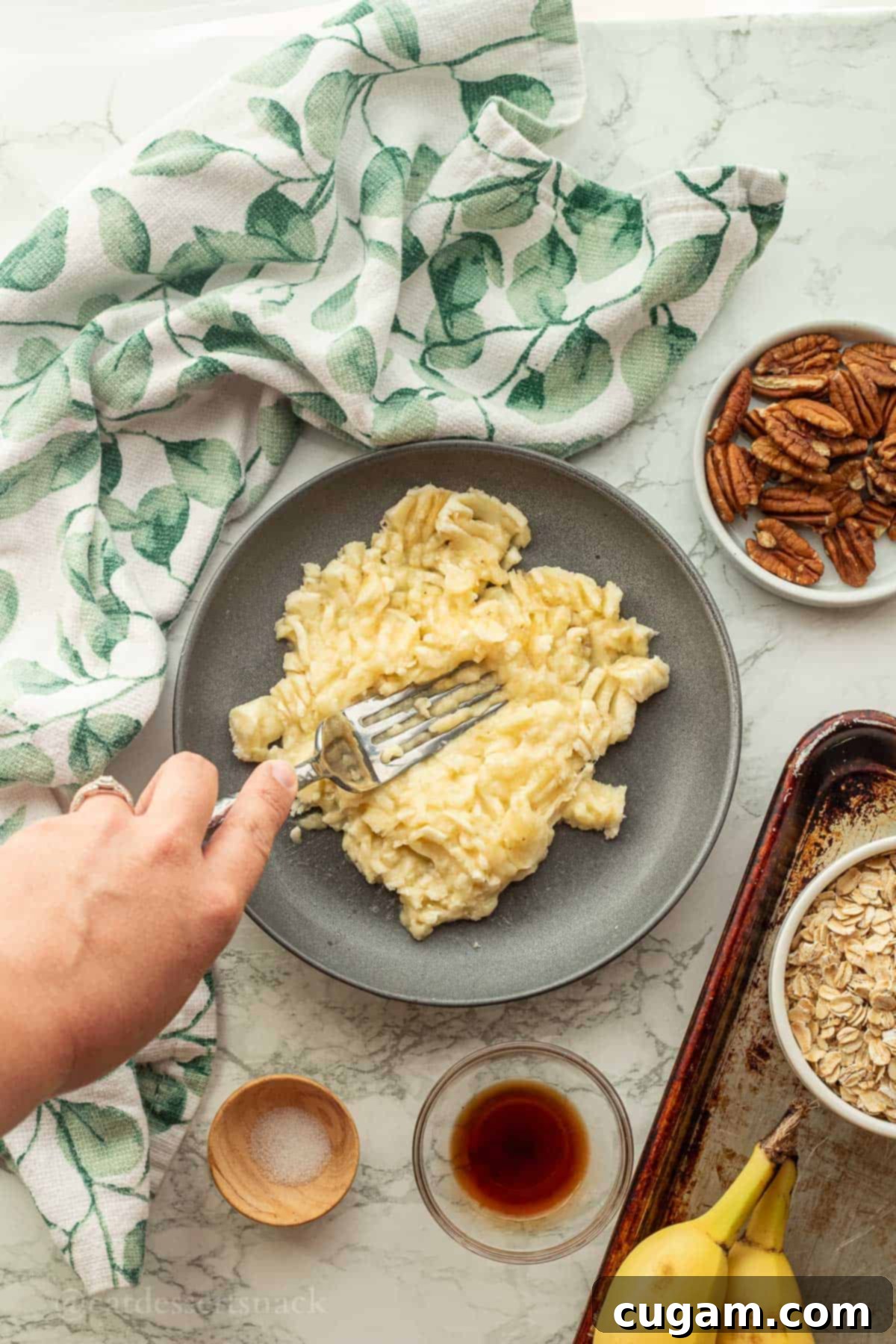 Banana Nut Oatmeal Bliss 5 Fork mashing banana on plate.