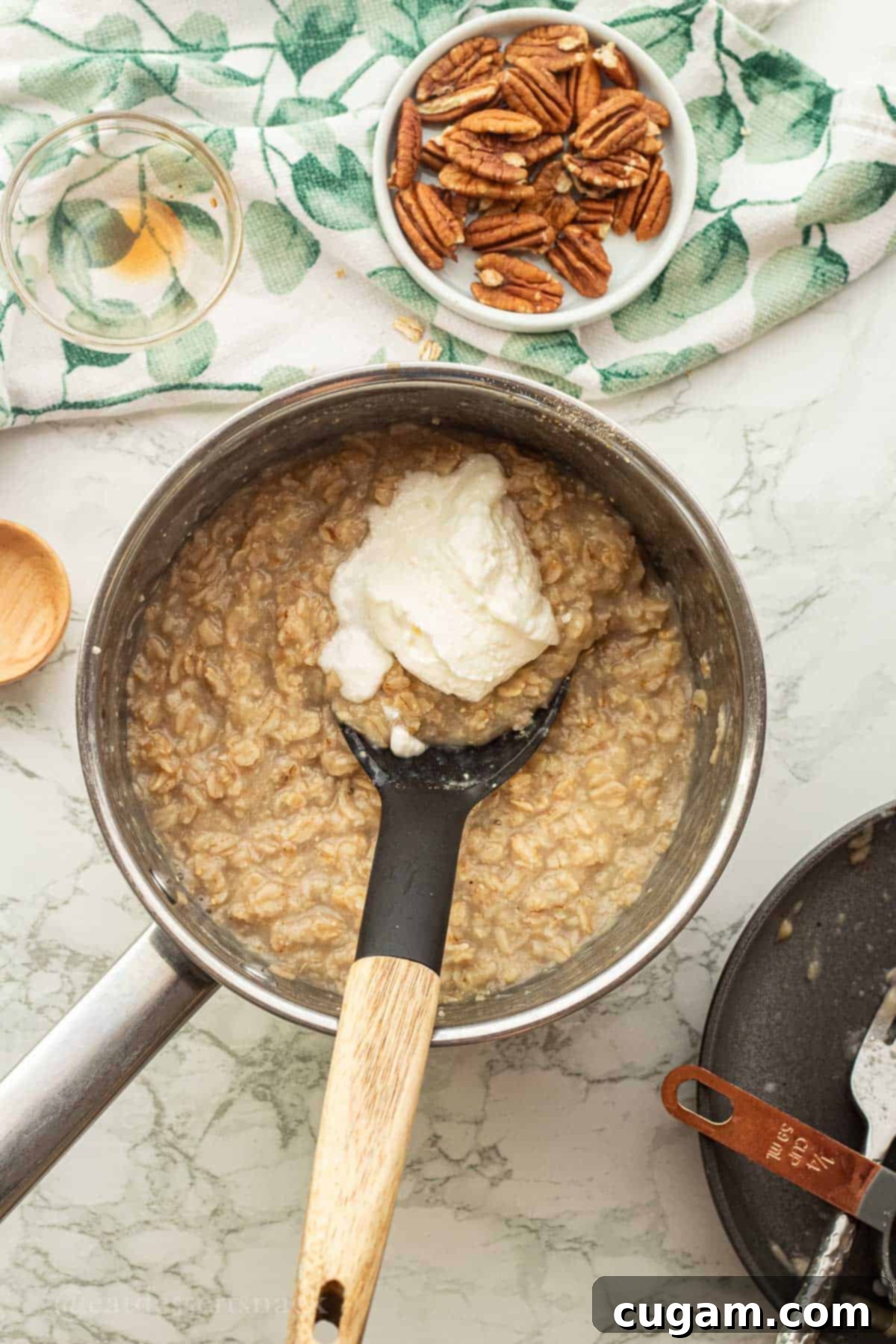 Banana Nut Oatmeal Bliss 8 Greek yogurt in pot of cooked oatmeal.