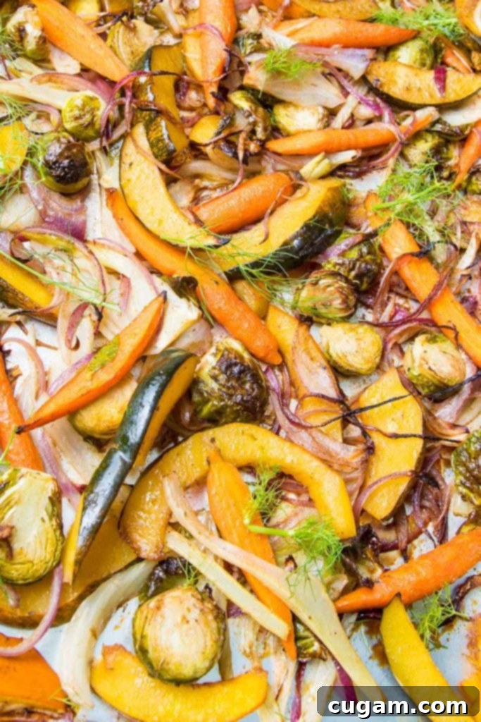 colorful yellows and oranges of squash and carrots highlight a tray of balsamic roasted veggies.