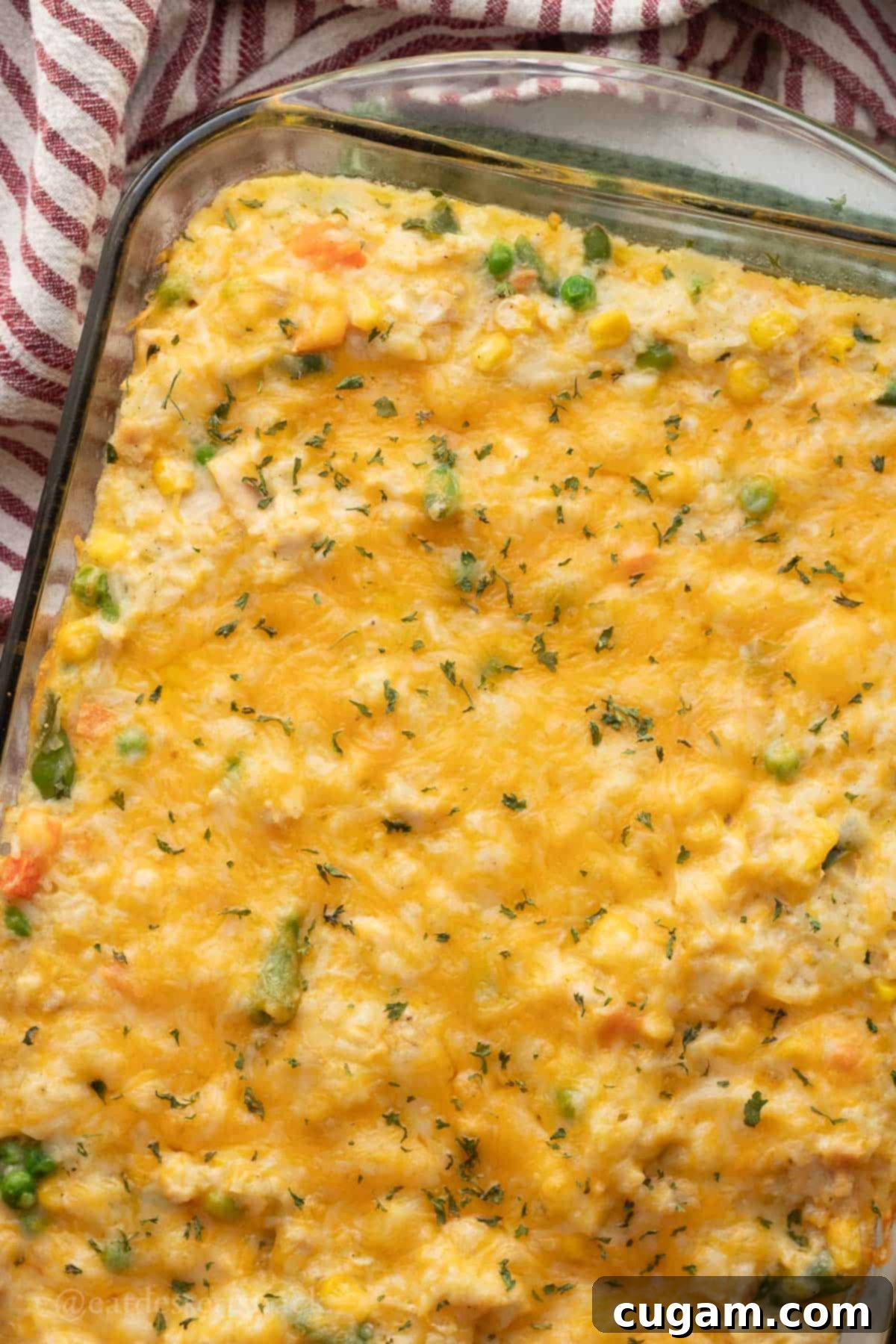 Chicken and Rice Vegetable Casserole 11 Baked chicken rice veggie casserole in glass baking dish.