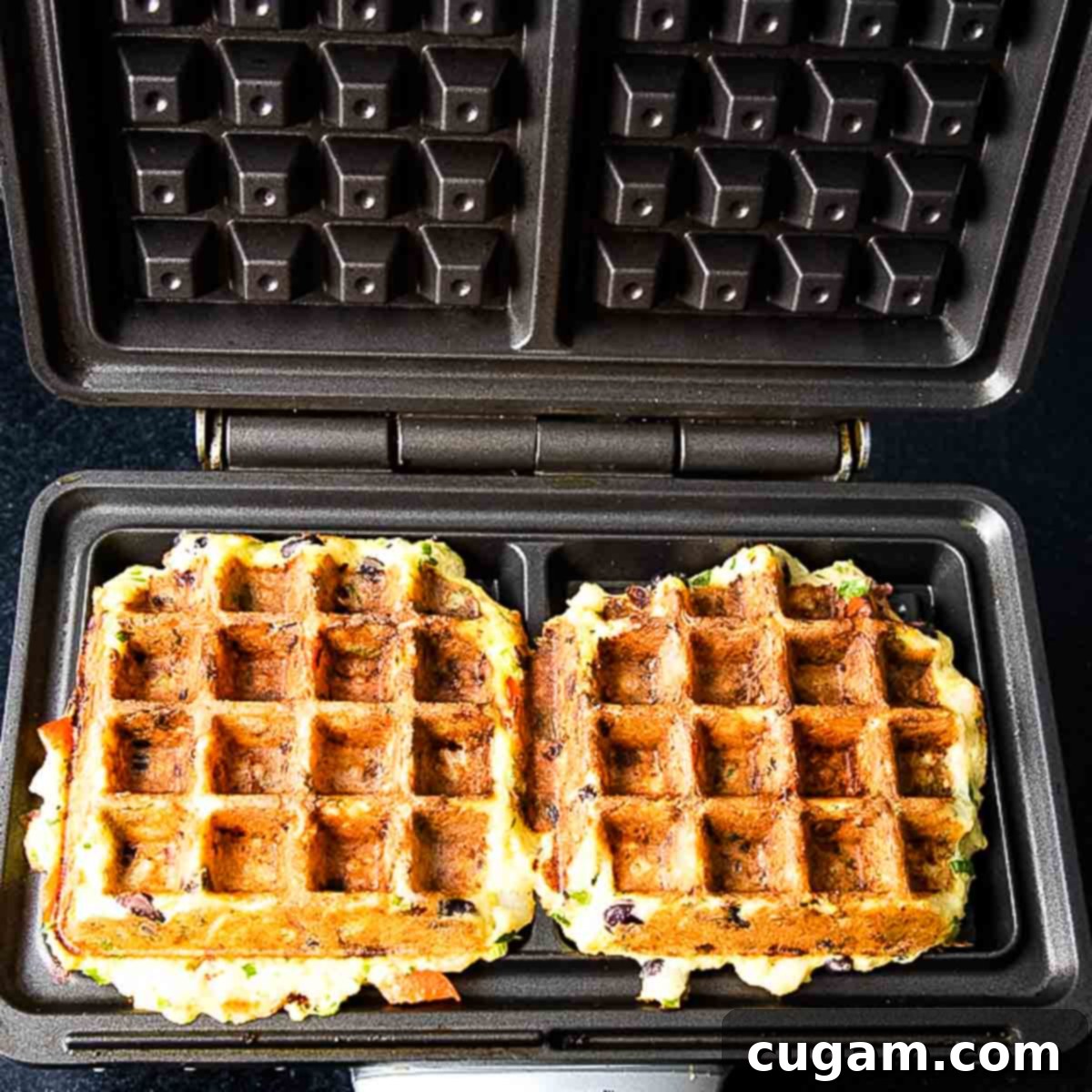 Golden brown mashed potato waffle cooling on a rack.