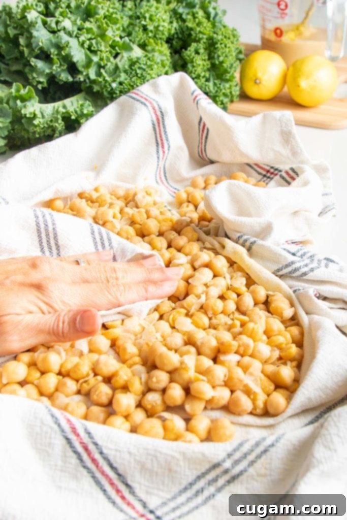 A kitchen towel is used to rub the skins off the chick peas