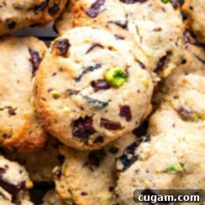 Chewy Vegan Gluten Free Chocolate Chunk Cookies 15 Pile of chocolate chunk cookies with pistachios and dried cherries.