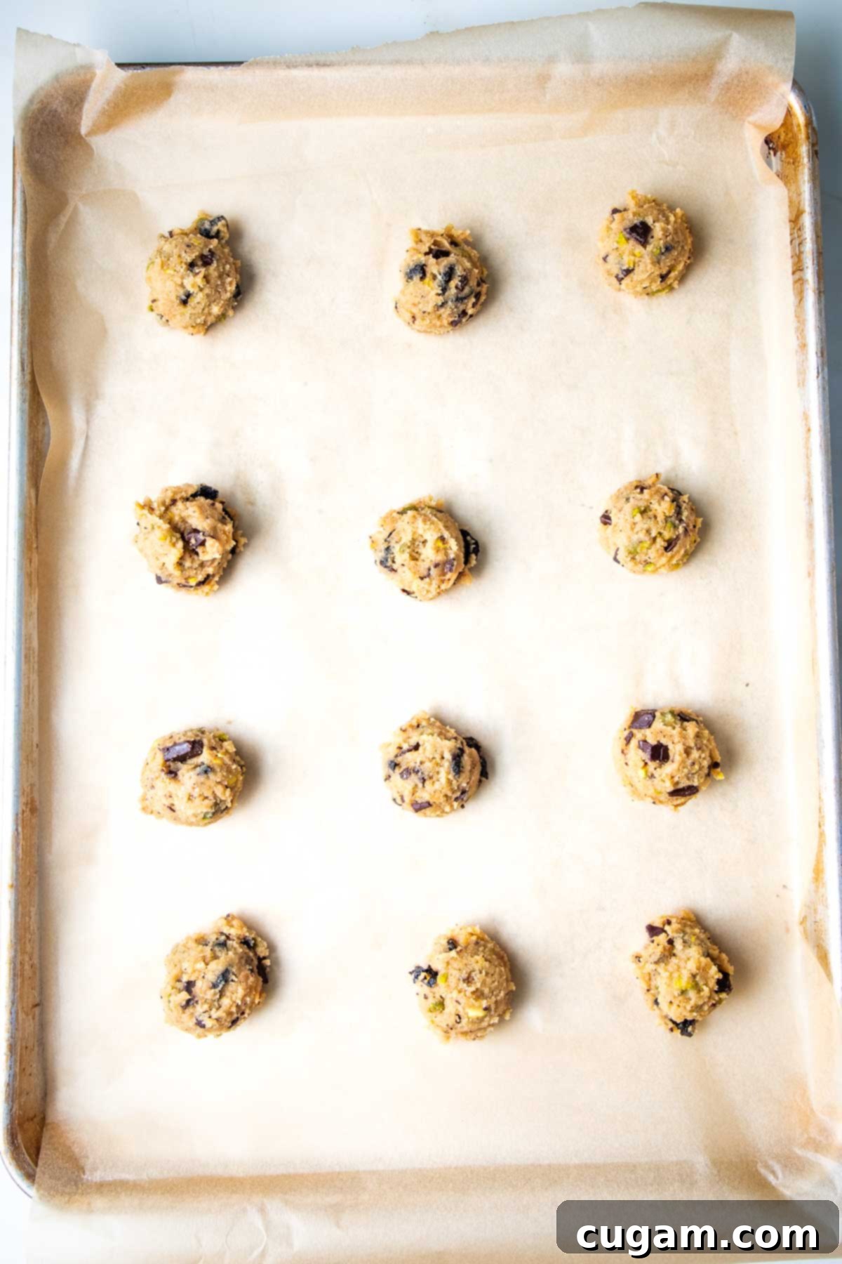 Chewy Vegan Gluten Free Chocolate Chunk Cookies 9 Balls of chocolate chunk cookie dough perfectly portioned on a parchment-lined baking sheet.