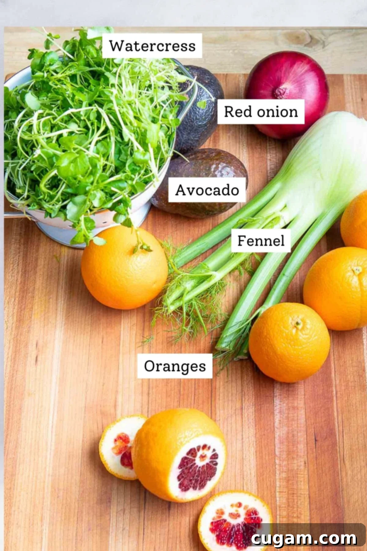 Labeled ingredients of whole foods: water cress, red onion, fennel, avocado, oranges.