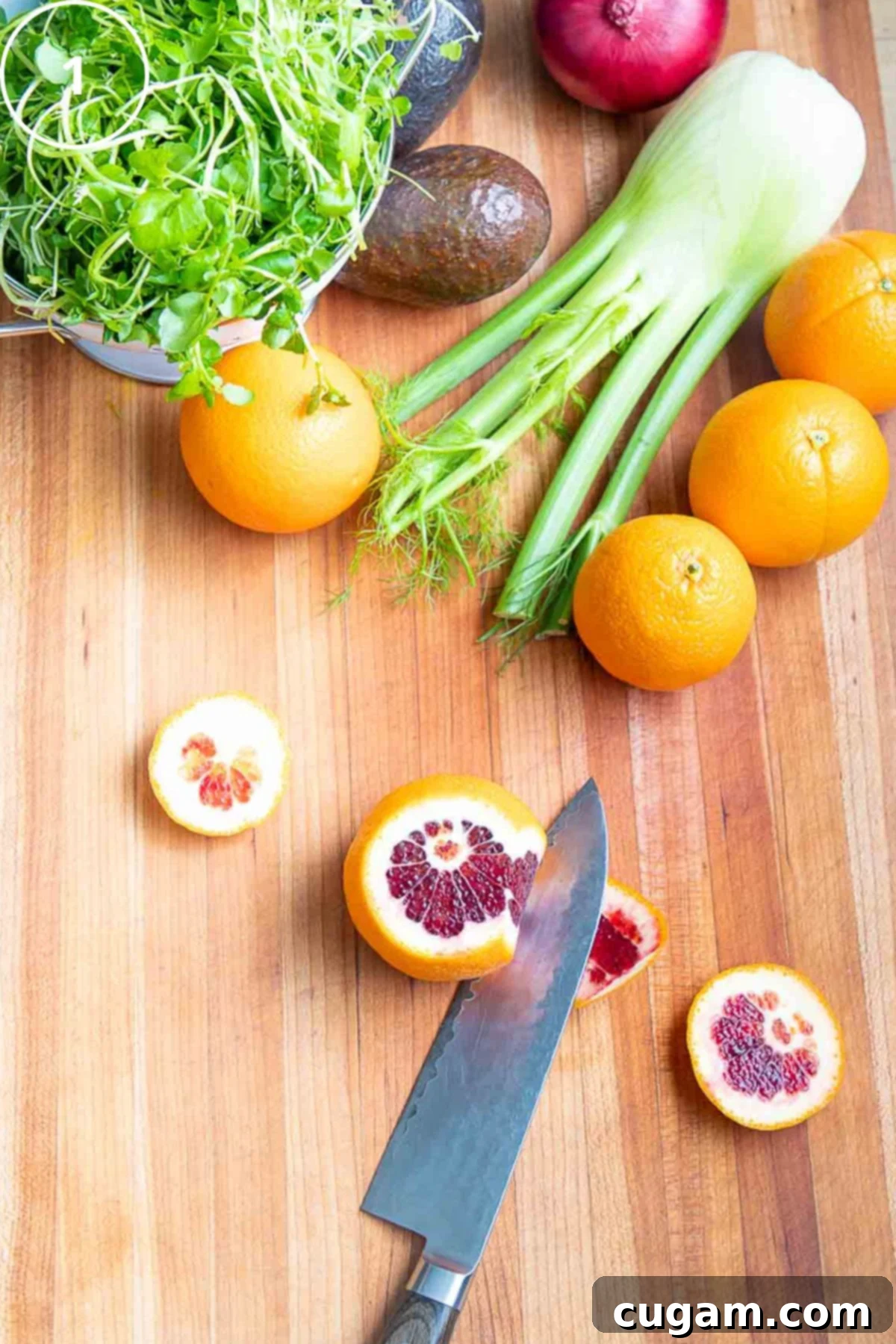 Demo on how to cut the peel off an orange with other colorful produce in the background.