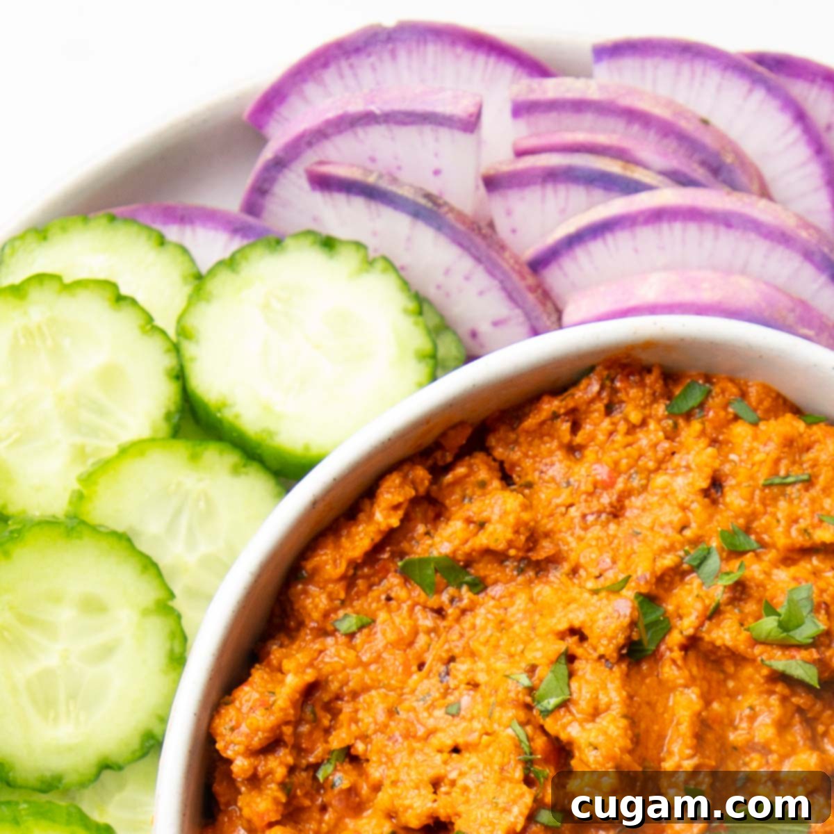A hearty rust colored spread with bring vegetables.
