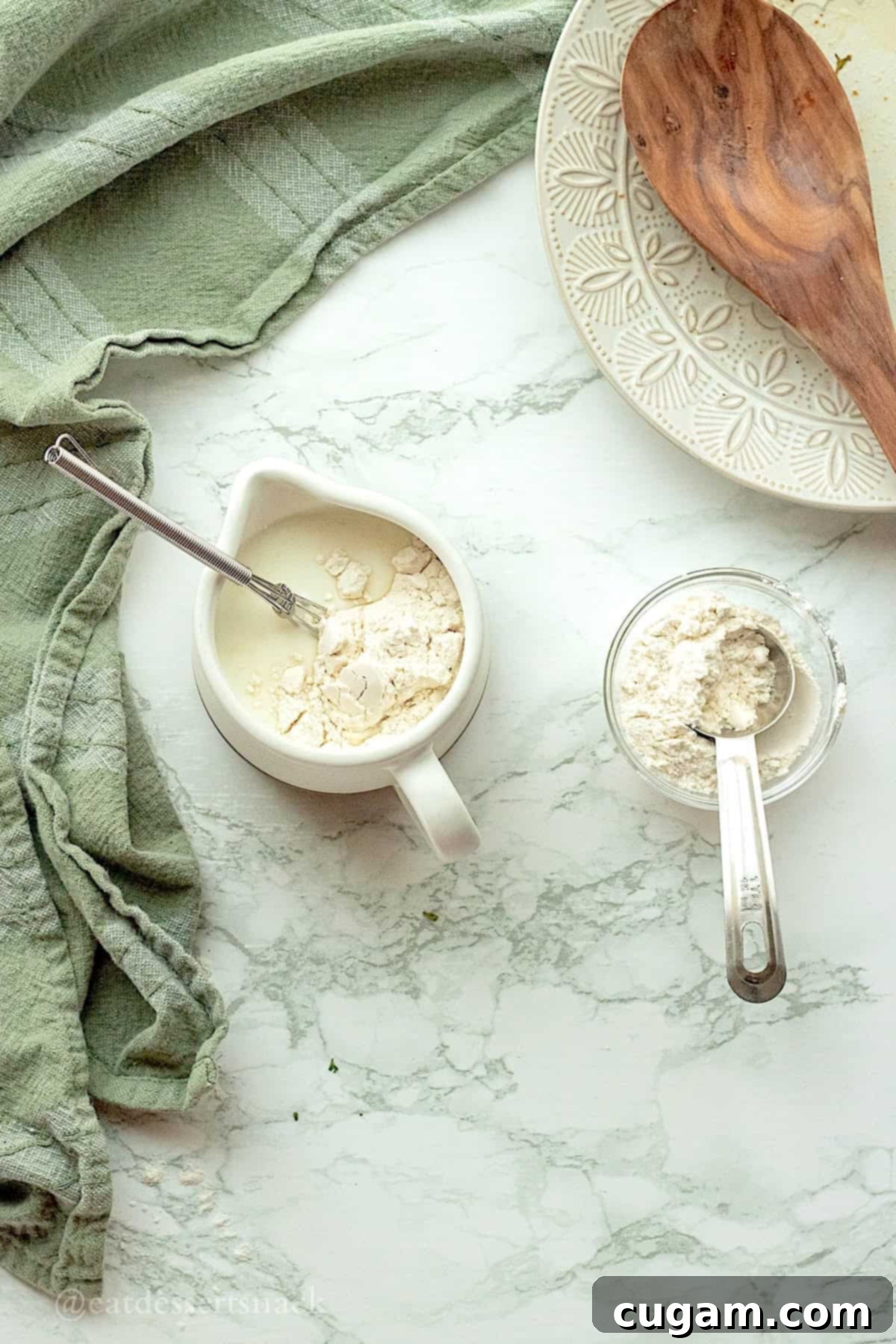 Flour, milk, and water in mixing measuring cup.