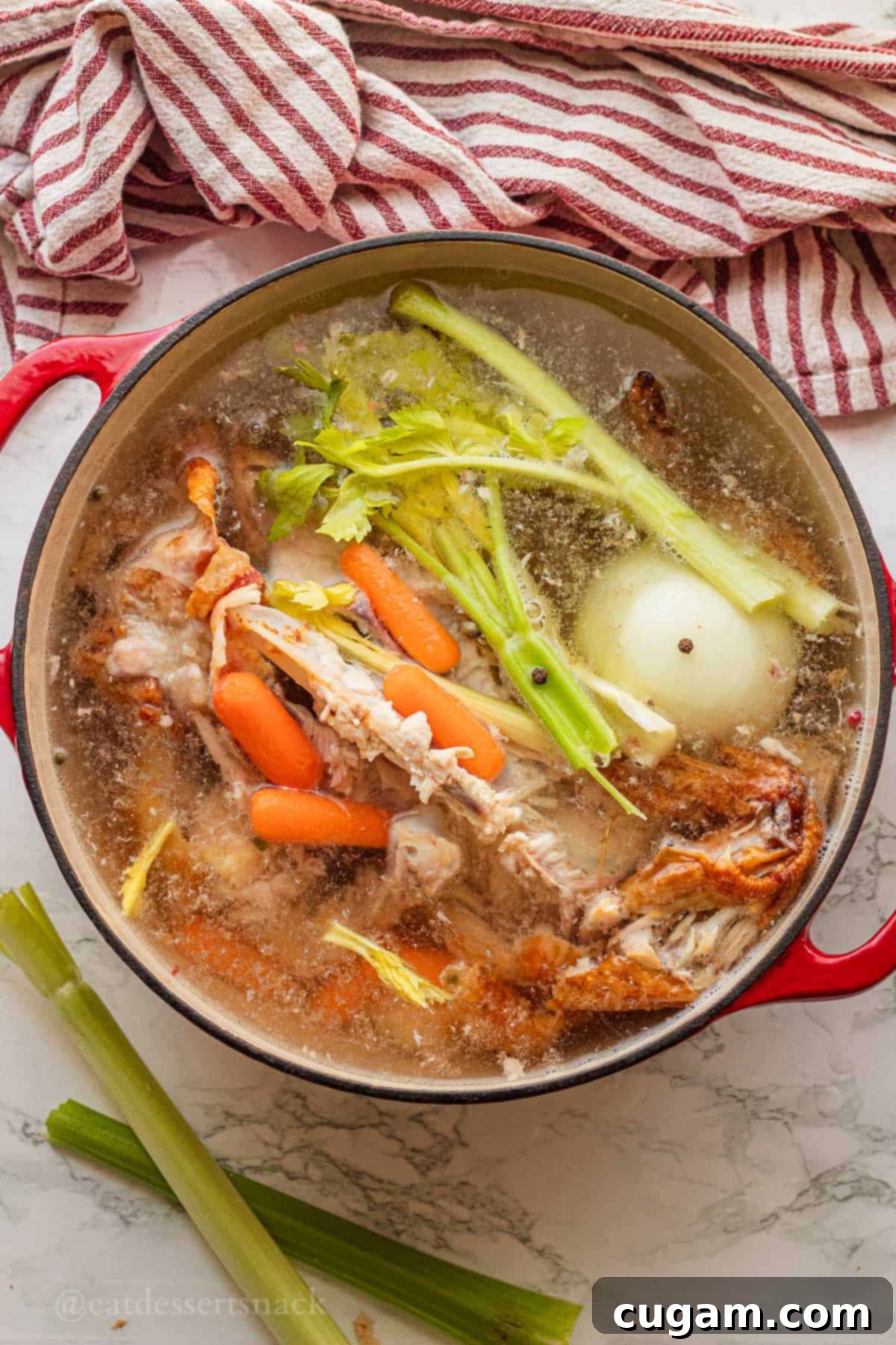 Nourishing Bone Broth Chicken Noodle Soup 5 Raw vegetables and chicken bones in pot of water with spices.