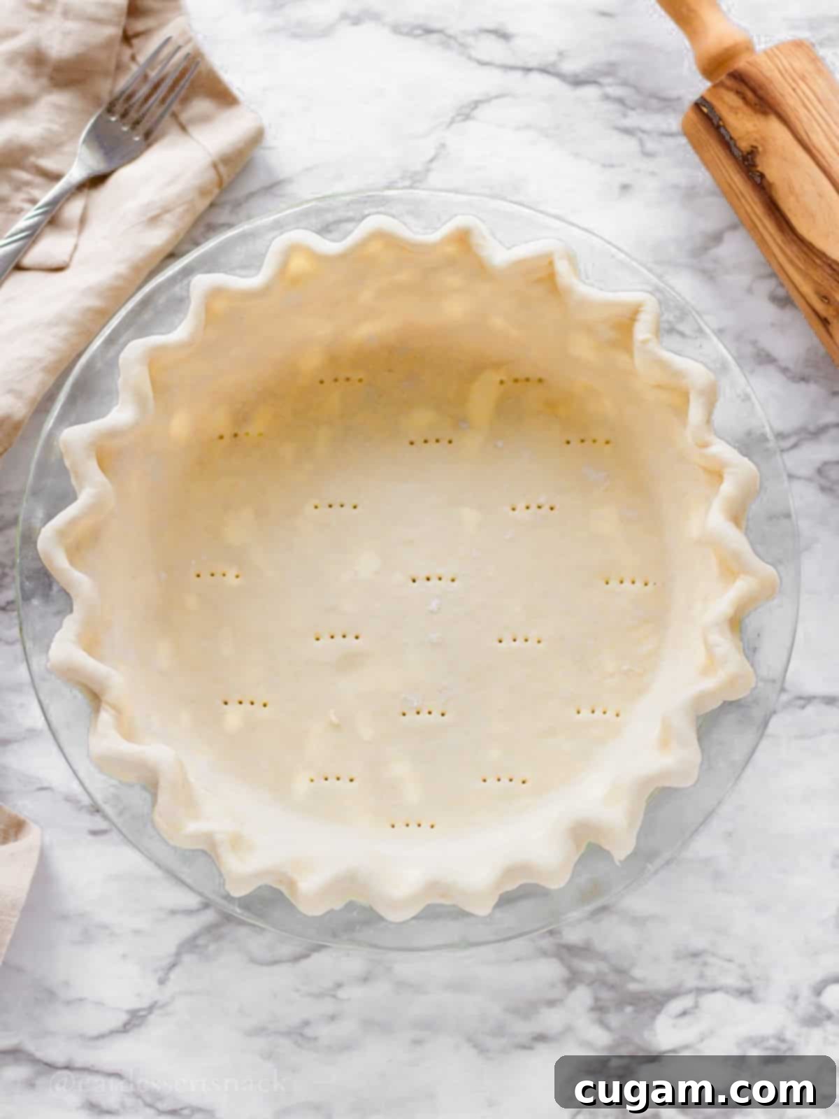 Raw cream cheese pie crust in glass pan