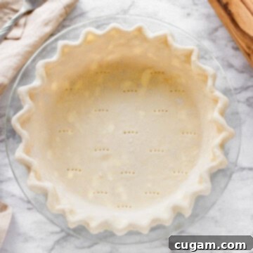 Raw cream cheese pie crust in glass pan
